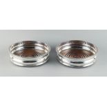 Property of a lady - a pair of silver plated coasters with turned wooden bases, each 5.5ins. (