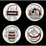 Property of a deceased estate - a set of four Fornasetti 'Vini e Liquori' coasters, one with rim