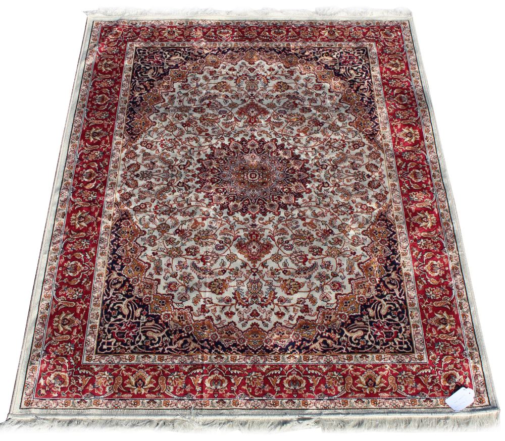 A Kashan style rug with beige ground, 75 by 53ins. (191 by 133cms.) (see illustration).