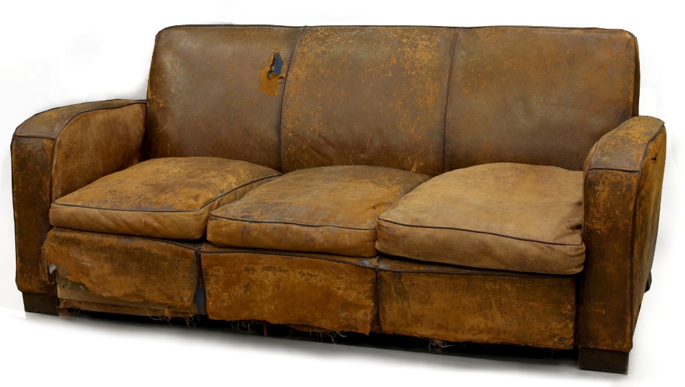 Property of a gentleman - a tan leather upholstered sofa, second quarter 20th century, with matching