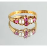 An 18ct yellow gold ruby & pearl ring, set with four cut rubies & two split pearls, size M (see