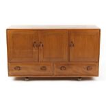 Property of a deceased estate - en suite with the two preceding lots - an Ercol elm 'Windsor'