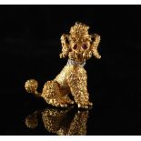 An 18ct yellow gold poodle brooch, with ruby eyes & diamond collar, 1.15ins. (2.9cms.) high,