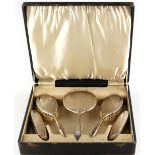 Property of a lady - a cased silver five piece dressing table mirror & brush set, Birmingham 1933 (