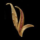 An 18ct yellow gold ruby & diamond three leaf brooch, set with fifteen round cut rubies & five round