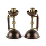 Property of a gentleman - a pair of Arts & Crafts copper & brass candlesticks or chambersticks, in