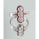 An 18ct white gold ruby & diamond ring, with three round brilliant cut diamonds set within a