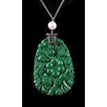 A Chinese carved untreated jadeite pendant depicting flowers & bamboo, the white metal mount with