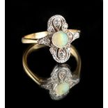 An 18ct yellow gold opal & diamond ring, with centre round opal in a pierced cross setting, size