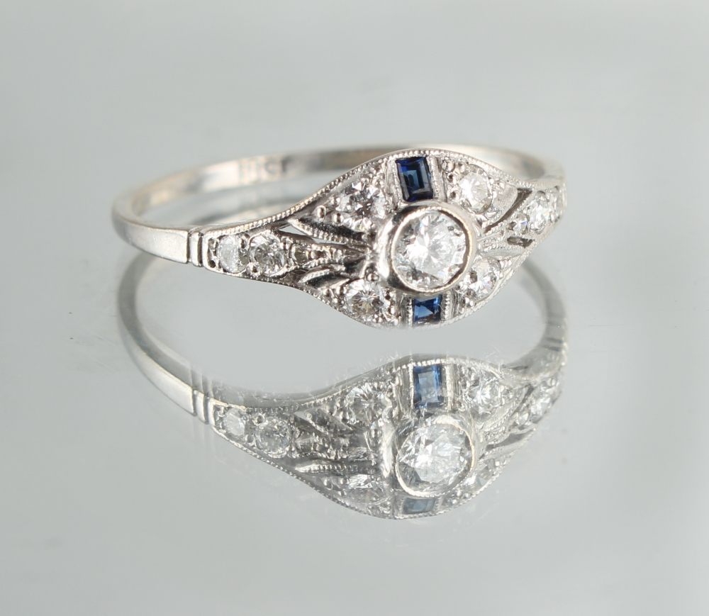 An 18ct white gold diamond & sapphire ring, with pierced oval millegrain setting, size P (see