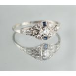 An 18ct white gold diamond & sapphire ring, with pierced oval millegrain setting, size P (see