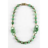 A Chinese jadeite bead & triple ring necklace, with gilt metal spacers, 16.5ins. (42cms.) long (