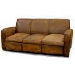 Property of a gentleman - a tan leather upholstered sofa, second quarter 20th century, with matching