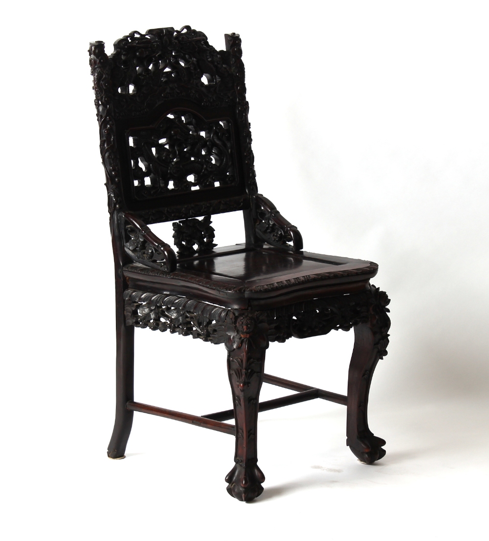 A Chinese profusely carved hongmu side chair, late 19th / early 20th century, with panelled seat &