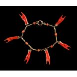 A yellow gold & coral fringe bracelet, with six pendant carved coral hands, the chain with seven