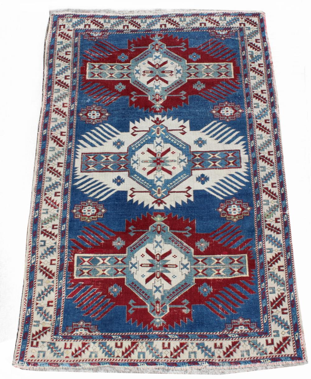 Property of a deceased estate - an early 20th century Caucasian Kazak rug, with navy field, 76 by