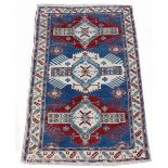 Property of a deceased estate - an early 20th century Caucasian Kazak rug, with navy field, 76 by