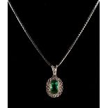 A 14ct white gold emerald & diamond oval pendant on 14ct white gold box link chain necklace, the