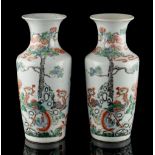 A pair of Chinese famille verte rouleau vases, late 19th / early 20th century, each painted with two