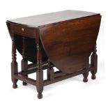 Property of a lady - an oak oval topped gate-leg table with end drawer, on turned supports, 37.5ins.