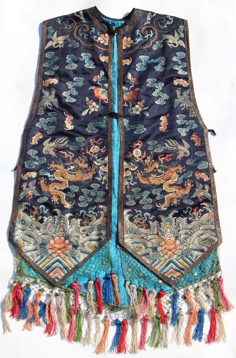 A Chinese navy blue silk sleeveless jacket, late 19th / early 20th century, decorated in gilt thread