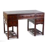 An early 20th century Chinese hongmu twin pedestal desk, 48ins. (122cms.) wide (see illustration).