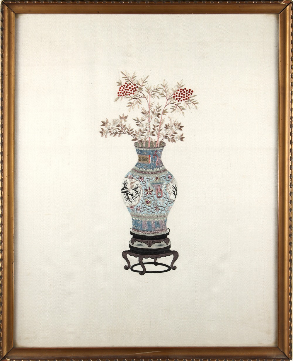 A Chinese embroidered silk panel depicting a vase of flowers, early 20th century, mounted in a