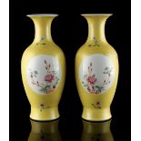 A pair of Chinese famille rose yellow sgraffito ground vases, with oval panels of butterflies &