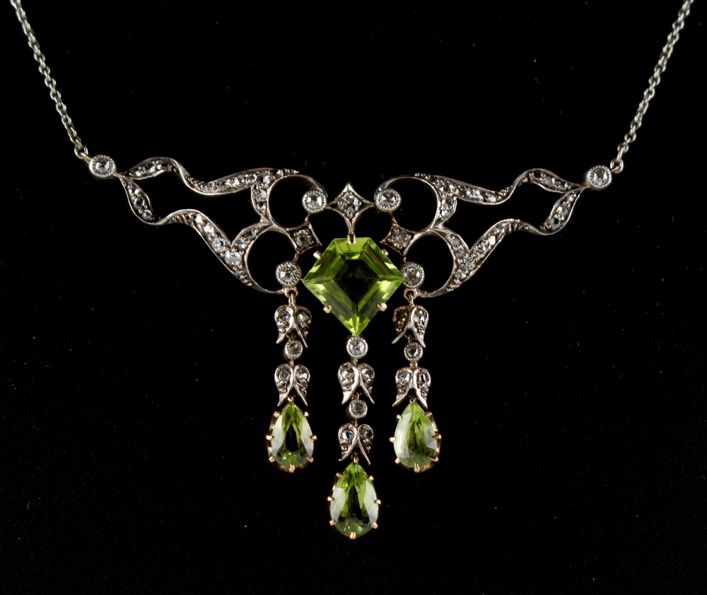 A Belle Epoque style peridot & diamond necklace, the central pentagonal table cut peridot