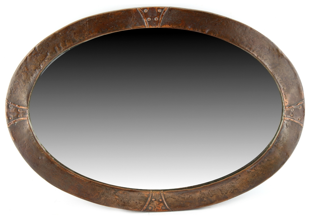Property of a deceased estate - an Arts & Crafts hammered copper oval framed wall mirror with