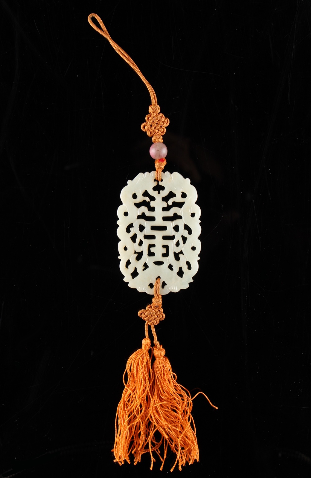 Property of a lady - a Chinese carved white jade pendant, second half 20th century, on orange