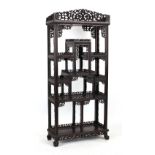 A good Chinese carved hongmu display cabinet, late 19th / early 20th century, with open shelves,