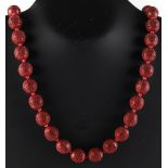 Property of a lady - a Chinese cinnabar lacquer bead necklace, the thirty-five individually