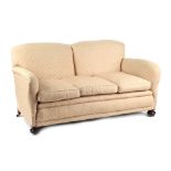 Property of a lady - an early 20th century upholstered sofa, with bun feet & casters, 66ins. (