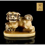 The Gill Collection of Japanese Netsukes - a carved ivory netsuke modelled as a standing