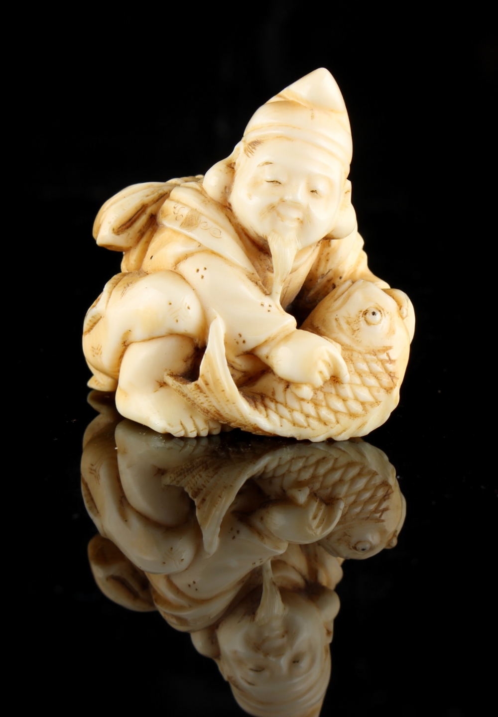 The Ronald Hart Collection of Japanese Netsukes - a carved ivory netsuke modelled as a kneeling - Image 2 of 5