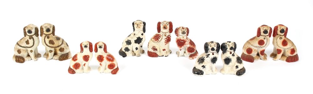 Property of a gentleman - three pairs of Victorian Staffordshire models of seated spaniels,