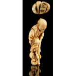 The Ronald Hart Collection of Japanese Netsukes - a carved ivory netsuke modelled as a standing