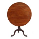 Property of a lady - a George III mahogany circular tilt-top occasional table with turned column &