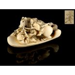 The Ronald Hart Collection of Japanese Netsukes - a carved ivory netsuke modelled as two men