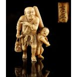 The Ronald Hart Collection of Japanese Netsukes - a carved ivory netsuke modelled as a fisherman &