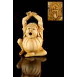 The Ronald Hart Collection of Japanese Netsukes - a carved ivory netsuke modelled as Okame seated