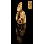 The Ronald Hart Collection of Japanese Netsukes - a carved ivory netsuke modelled as a boy on a