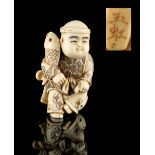 The Ronald Hart Collection of Japanese Netsukes - a carved ivory netsuke modelled as a boy sitting