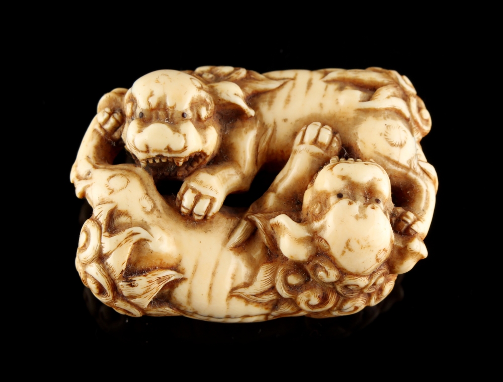 The Ronald Hart Collection of Japanese Netsukes - a carved ivory netsuke modelled as two recumbent