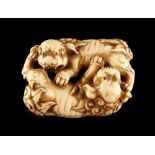 The Ronald Hart Collection of Japanese Netsukes - a carved ivory netsuke modelled as two recumbent