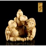 The Ronald Hart Collection of Japanese Netsukes - a carved ivory netsuke modelled as three figures