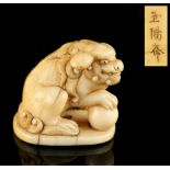 The Gill Collection of Japanese Netsukes - a carved ivory netsuke modelled as a karashishi, his