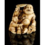 The Ronald Hart Collection of Japanese Netsukes - a carved ivory netsuke modelled as Hotei seated