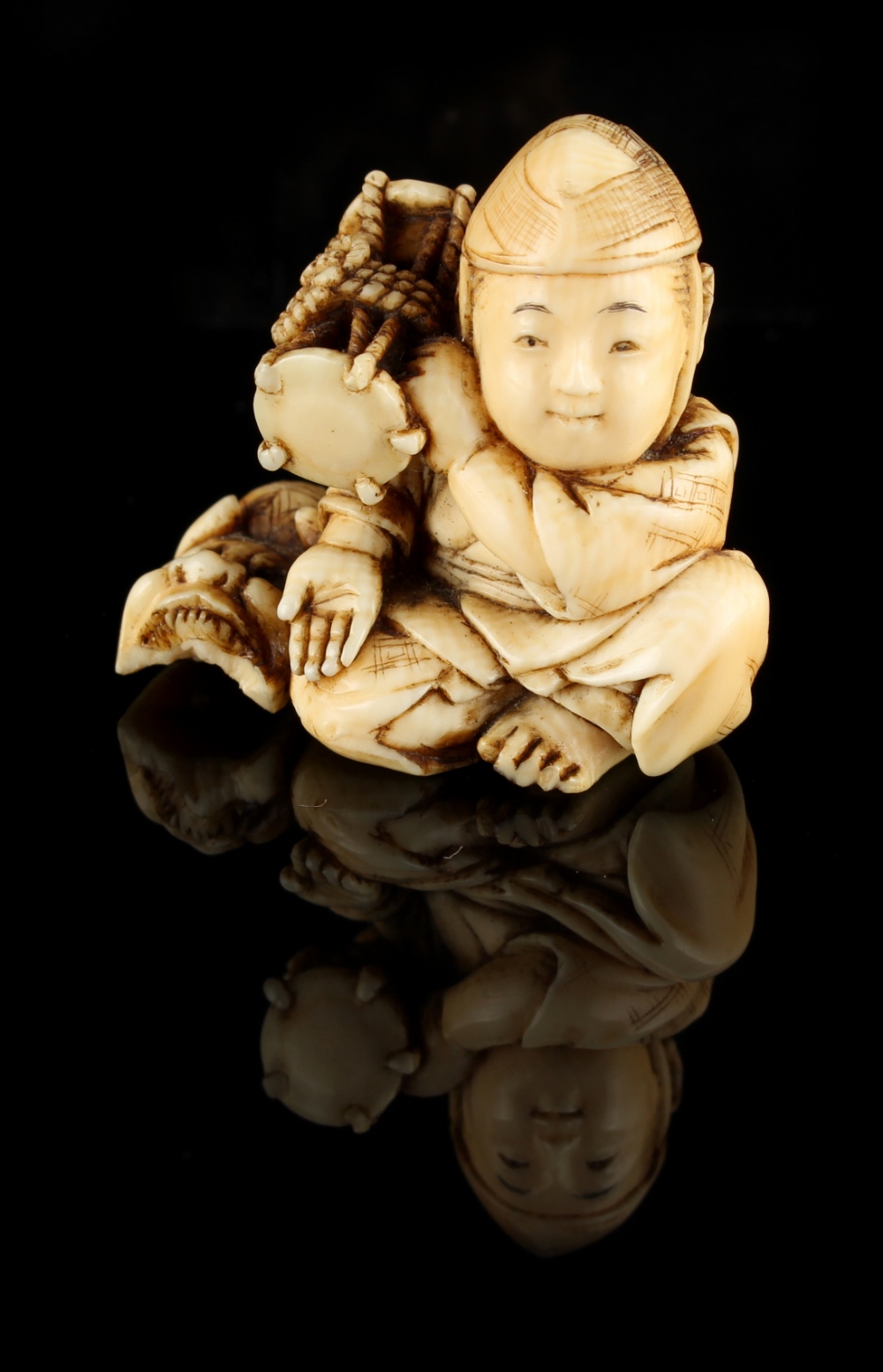 The Ronald Hart Collection of Japanese Netsukes - a carved ivory netsuke modelled as a seated boy - Image 3 of 6